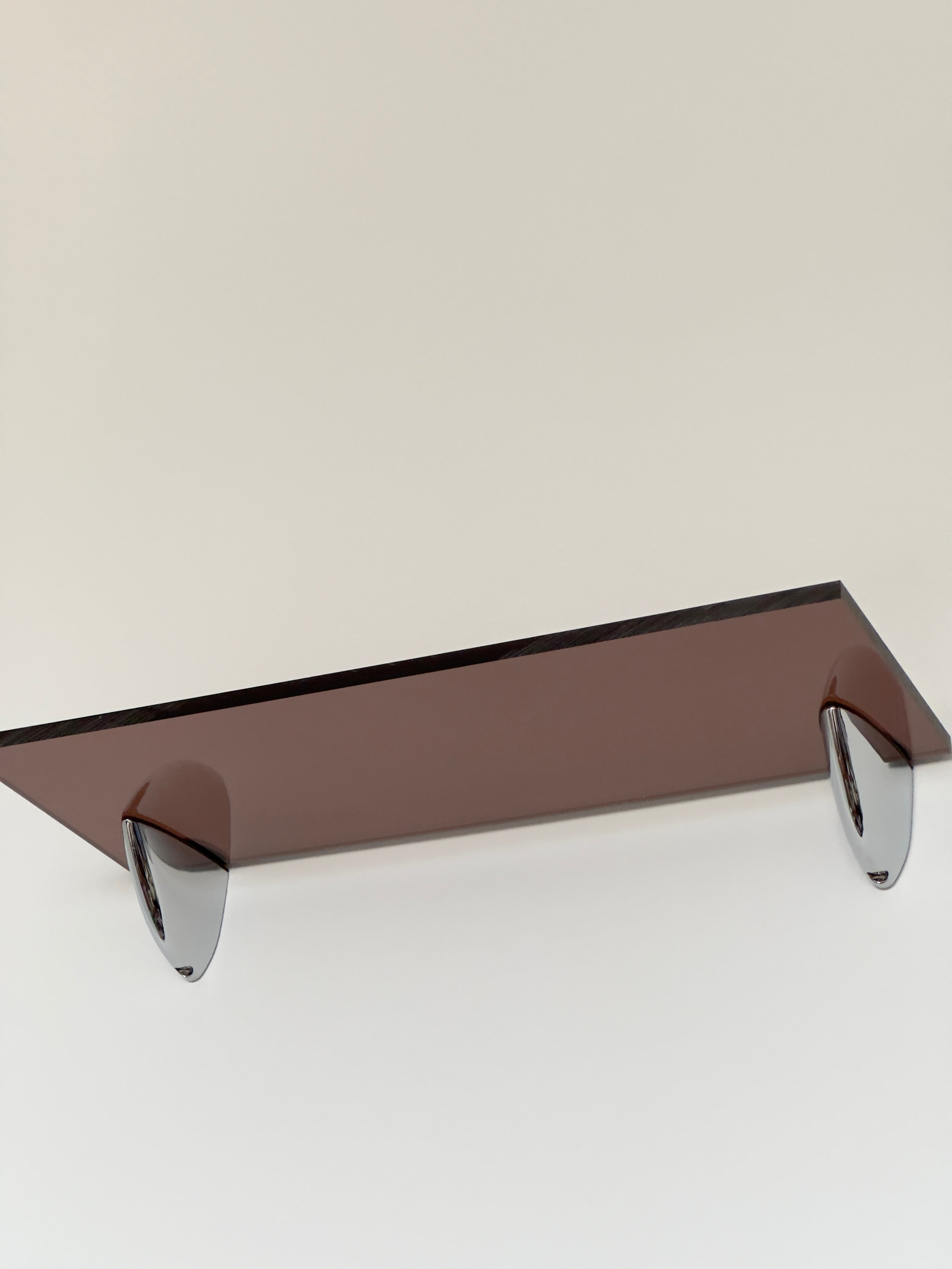 Wall shelf in Acrylic glass and chrome, tinted in smoky brown color shade, from French design studio 70space, inspired by the 70s interior design, gives a retro vintage and minimalist modern charm, solid materials in plexiglass / PMMA
