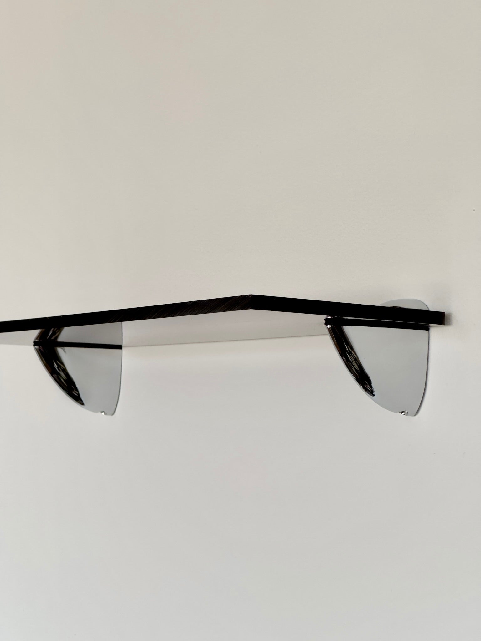 Wall shelf in Acrylic glass and chrome, tinted in smoky brown color shade, from French design studio 70space, inspired by the 70s interior design, gives a retro vintage and minimalist modern charm, solid materials in plexiglass / PMMA